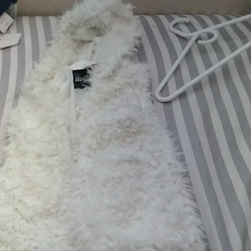 A fluffy vest with a hood